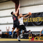 St. Pauls Tristan Tapia leaps up at the basket while Phoenix Sons Dean Manglona attempts to block. (Photo by Michael Blas)