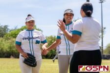 Southern Dolphin Jonese Taiminglo and Jeraila Martinez celebrate as they move into the next inning. (Photo by Michael Blas)