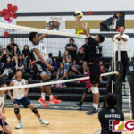 Harvest Eagles Alan Thomas connected with a spike as Tiyan Titans Neil Ericsson gets his fingers on the ball. (Photo by Michael Blas)