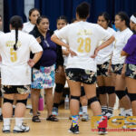 George Washington Geckos Coach Bobbi Quinata speaks to her team prior to the second set of the game. (Photo by Michael Blas)