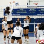 Academy Cougar Rebecca Salas attempts to block a spike from St. Paul Warrior Keiani Pangelinan. (Photo by Michael Blas)