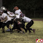 Okkodo Bulldogs Christian Reyes gets wrapped up by the Simon Sanchez Sharks defense. (photo by Bout It Productions)