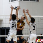 FD Friars Jeremiah Nguyen with a spike while St. Paul Warriors John Kyle Rabino and Jonathan Hotelling contests. (Photo by Michael Blas)