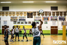 JFK Islanders Irvin White delivers a serve to the awaiting Tiyan Titans. Photo by Bout It Productions