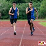 A pair of St. Paul Warrior runners sprint down to finish their IIAAG HS Cross Country meet against the Okkodo Bulldogs. (Photo by Michael Blas)