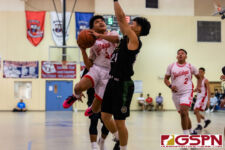 Okkodo Bulldog Kobe Santos flies in for a layout while JFK Islander Ralf Manalac defends. (Photo by Michael Blas)