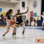 Academy Cougars Coco Paulino looks for an open teammate while Guam High Panthers Katrina Davis puts the pressure on. (Photo by Michael Blas)