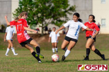 St. John's Knight Jordan Baden and ND Royal Maya Iriarte go in for the kick. (Photo by Michael Blas)