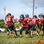 Faha Outlaws Zavier Camacho hands the ball off to Josiah Quintanilla. (photo by Bout It Productions)