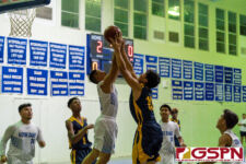 ND Royal Nolan Sablan and Damien Dela Cruz fight for the rebound in the first quarter. (Photo by Michael Blas)