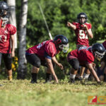 Faha Outlaws Jose Takai Jr. II & his defense line up while Josiah Quintanilla calls the shots. (photo by Bout It Productions)