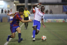 Quality Distributors' Ernest Baah looks to control the ball as he is pressured defensively by Bank of Guam Strykers' Ian Mariano during a Week 11 match of the Budweiser Soccer League Premier Division Saturday at the Guam Football Association National Training Center. The Strykers defeated Quality 2-1.