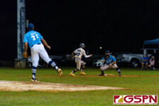 GW Gecko Jonah Peredo heads back to first on a check by ND Royal Noah Peredo. (Photo by Michael Blas)