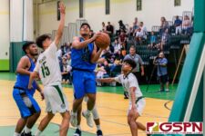 St. Paul Warrior Thelo Orichiro gets through the JFK Islander defense for a shot at the basket. (Photo by Michael Blas)
