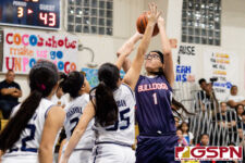 Okkodo Bulldog Angeli Dacanay pops for two points over Academy Cougars Alura Hernandez and Alexis Fejeran. (Photo by Michael Blas)