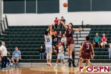 St. Paul Warrior Audrey Dela Cruz sinks in a three against FD Friar Matthew Fegurgur. (Photo by Michael Blas)