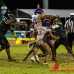 JFK Islanders Andrew Perez gets the ball out with GW Gecko defenders in his face. (Photo by Michael Blas)