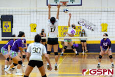 GW Gecko Lola Aguon spikes as Tiyan Titan Andreyana Sejalbo goes up to defend. (Photo by Michael Blas)