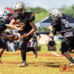 Raiders QB Peter Concepcion fakes a hand off to Tristan Jay Burgos and gives the ball to Peter Mesa. (Photo by Michael Blas)