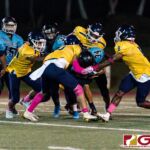 Southern Dolphin Cerilo Reyes gets clustered by the Panther defense for a short gain on the play. (Photo by Michael Blas)