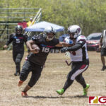 Sindalu Raiders Leticia Blas stiffarms Team Legacy's Jessica Taitague for extra yardage. (photo by Bout It Productions)
