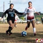 St. Paul Warriors Lovely Nilooban and Eli Errett chases the ball down the sidelines to keep it in play. (Photo by Michael Blas)