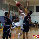 GW Geckos Ricky Macias powers his way towards the basket while Okkodo Bulldogs Alvin Aromin contests. (Photo by Michael Blas)