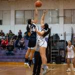GW Geckos Kirsten Santos and St. Paul Warriors Niah Siguenza contest on the jump ball to start their 2018 IIAAG high school girls basketball game. (Photo by Michael Blas)