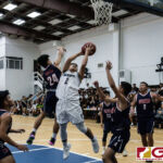 St. Paul Warriors Nich Fermin snatches the offensive rebound and adds two points to the Warriors lead. (Photo by Michael Blas)