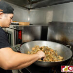 Boka Box Nutrition Professional/Owner Jesse E. Rosario prepares a set of meals during their daily meal prep. (Photo by Michael Blas)
