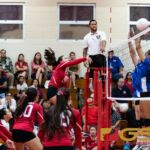 St. John's Knights Tylee Shepherd spikes past the Notre Dame Royals blockers. (Photo by Michael Blas)
