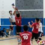 Harvest Eagles Jacob Oshiro connects with a spike as Knights Warren Chen contests. (Photo by Michael Blas)