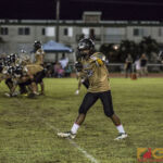 Jaren Mayo checks his place in line from the sideline ref before the ball is snapped (photo by Michael Ebio)