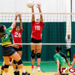 JFK Islander Kiyoni Yamaguchi spikes as St. John's Knight Angeline Del Carmen goes up for a block. (Photo by Michael Blas)