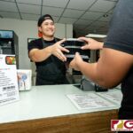 Boka Box Nutrition Professional/Owner Jesse E. Rosario hands over a set of meals to a customer. (Photo by Michael Blas)