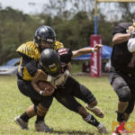 Justin Tanguileg pushes forward for extra yardage while his defender wraps him up. (photo by Bout It Productions)