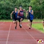 St. Paul Warrior runners and lone Okkodo Bulldog runner sprint down the final stretch of the race. (Photo by Michael Blas)