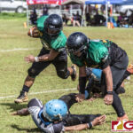 Guam Packers Eric John Sablan gets help from teammate Cohen Blas for extra yardage. (photo by Bout It Productions)