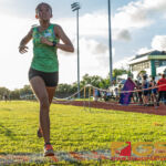 JFK Islanders Mya Tolerson crosses the finish line in third place with a time of 22:27.06. (Photo by Michael Blas)