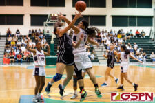 St. Paul Warrior Monica Giger goes in for a layup as Okkodo Bulldog Angeli Dacanay contests. (Photo by Michael Blas)
