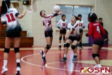 St. John's Knight Ella Wigsten gets a touch on the ball off a serve from the Raiders. (Photo by Michael Blas)