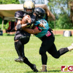 Southern Dolphins Lawrence Aflague makes the tackle on Titan Deshawn Warren. (Photo by Michael Blas)