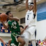 JFK Islanders Jerry Ngraremiang powers his way towards the bucket as Harvest Eagles Jacob Oshiro contests. (Photo by Michael Blas)