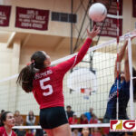 St. John's Knights Tylee Shepherd leaps up to launch the ball over the net through the AOLG Cougars blockers. (Photo by Michael Blas)
