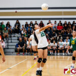 JFK Islander Tiana Guerrero makes a connection with the ball and sends it over to the Titans. (Photo by Michael Blas)