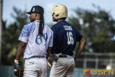 Both players from Team Pohnpei & Team Guam look on to the infield from first base. ( photo by Bout It Productions )