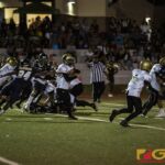 Tiyan High Titans Davin Mojica protects the ball after receiving the kickoff. (photo by Bout It Productions)