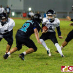 JFK Islander WR Nico Velez jukes as Dolphins Isiah Topasna looks to make the tackle. (Photo by Michael Blas)