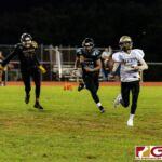 Tiyan Titan Kaekoa Leon Guerrero scrambles for some room as the Islanders close in for the sack. (Photo by Michael Blas)