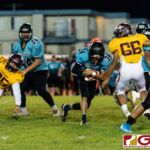 Southern Dolphin Cerilo Reyes slips past Friar defender Gene Arriola for more gain on the play. (Photo by Michael Blas)
